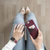 Colonial-Red-and-GrapeVine-Iphone-8-plus-leather-case-on-top-of-a-jeans-for-woman-bs