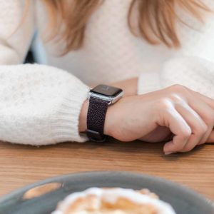 Purple-Rain-AW-stingray-leather-band-with-hand-on-a-wood-table