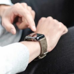 Deep-Leaf-AW-green-full-grain-leather-band-with-hand-on-black-jeans