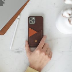 Cigar-iphone-12-pro-dark-brown-leather-with-gold-monogrma-on-top-of-a-white-marble