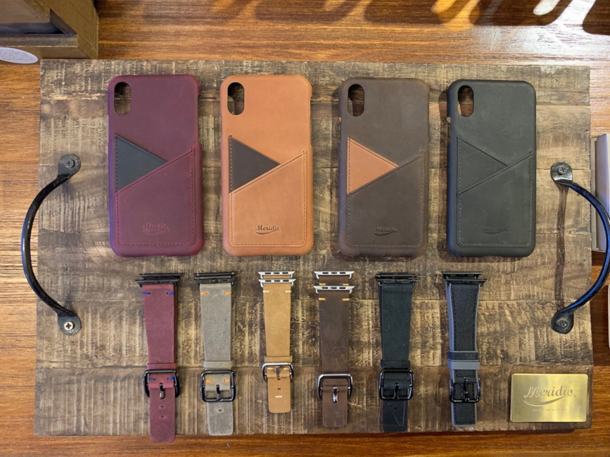 Bands-and-iphone-leather-cases-on-top-of-a-vintage-wood-table