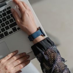 Galaxy-watch-active-Arctic-night-blue-vintage-leatehr-band-with-ajeans-sportwear-for-her-on-top-view-editing-with-a-macbook-keyboard