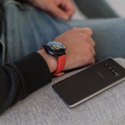 Galaxy-watch-active-red-leather-band-close-to-a-samsung-mobile
