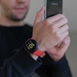 Galaxy-watch-active-red-leather-band-shooting-a-photo-with-his-smasung-mobile