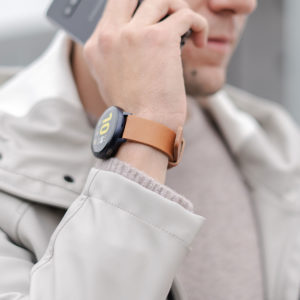 galaxy-watch-active-tawny-on-wrist-for-him-close-to-a-grey-coat