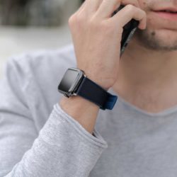 Apple-watch-deep-blue-natural-rubber-band-for-him-close-to-an-iphone