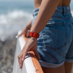 Apple-watch-orange-tide-band-recycled-ocean-plastic-woman-with-a-paddle-surf-going-to-sea