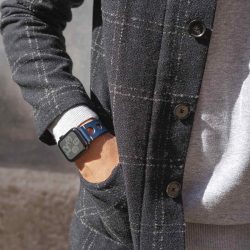 AW blue full grain leather band for man in a sunny day wearing a coat